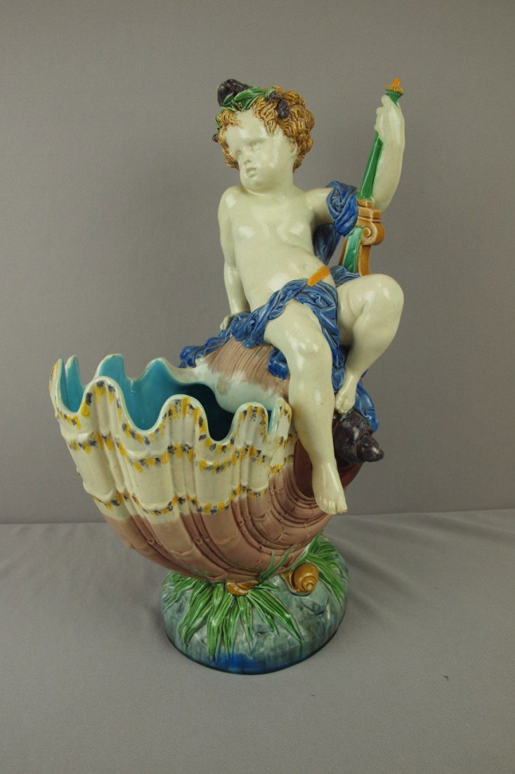 MINTON majolica table center in the form of a larg: MINTON majolica table center in the form of a large conch shell with putti, shape no. 1539, 18", professional repair to putti arm and rim of shell