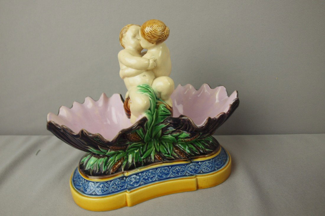 MINTON majolica figural double salt with kissing p: MINTON majolica figural double salt with kissing putti between two shells supported by bullrushes, unusual form, shape no. 318, 6 3/4"h, 8 1/2"w