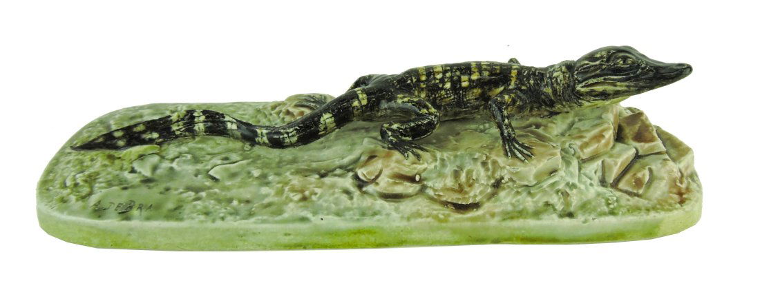 Rare Hippolyte Hautin Boulanger & Cie,: (Choisy le Roi, France) Majolica paperweight c.1880 with inscribed mark 'A De Bra' to base, formed as a large alligator laying on a rocky ground upon a pedestal base, 9"l, 2 1/2"h. Only known example.