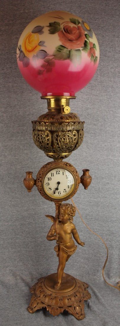 Brass and iron banquet lamp with clock and cherub: Brass and iron banquet lamp with clock and cherub, 35 1/2", electrified, no chimnet
