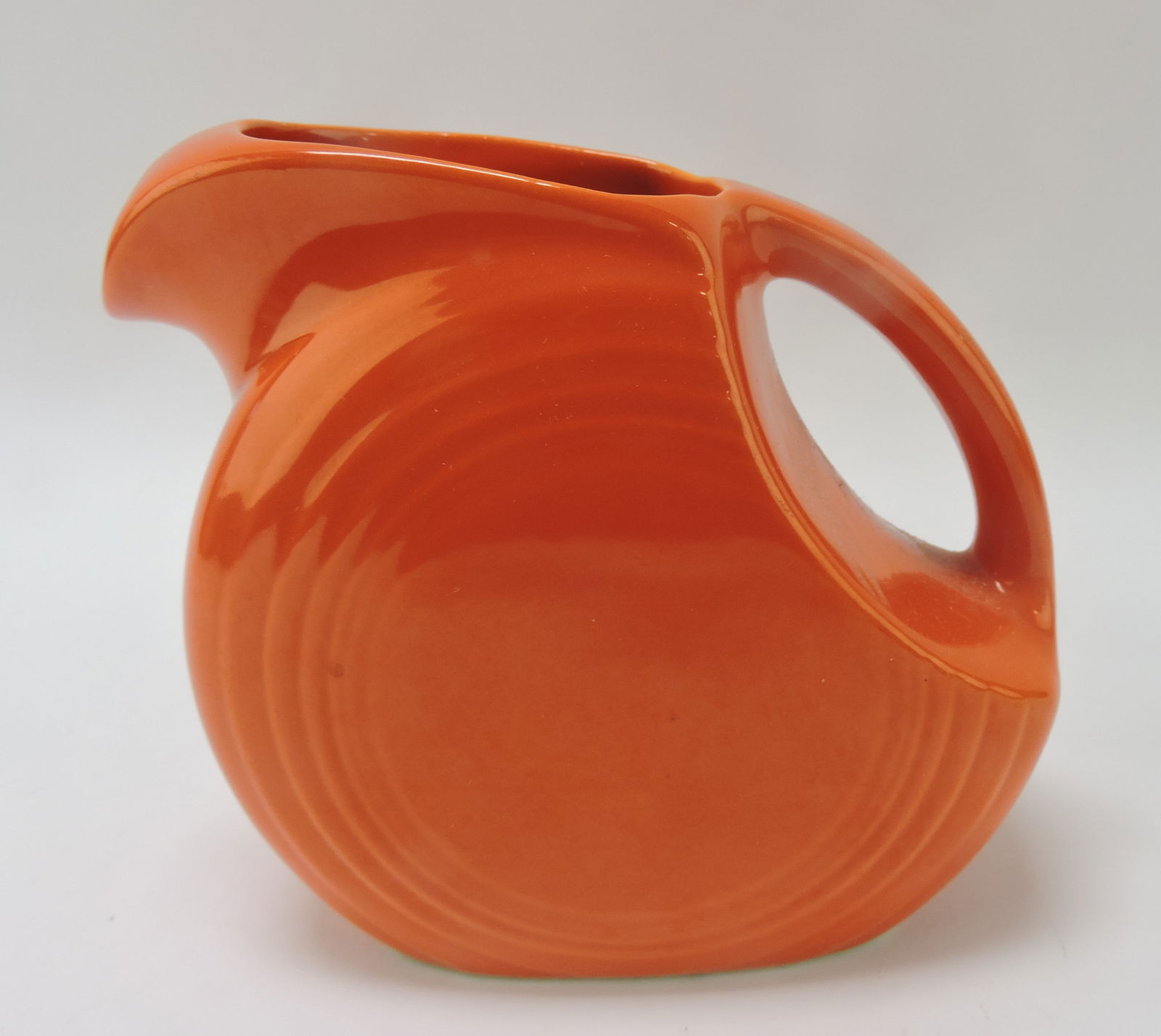 Fiesta disc juice pitcher, red, rim nick (1 of 1)