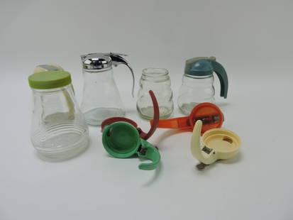 Lot of go along syrup pitchers and tops: .