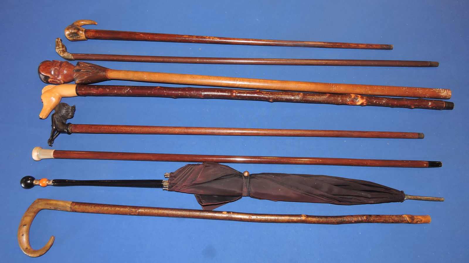 Lot of 7 walking sticks and umbrella (1 of 2)