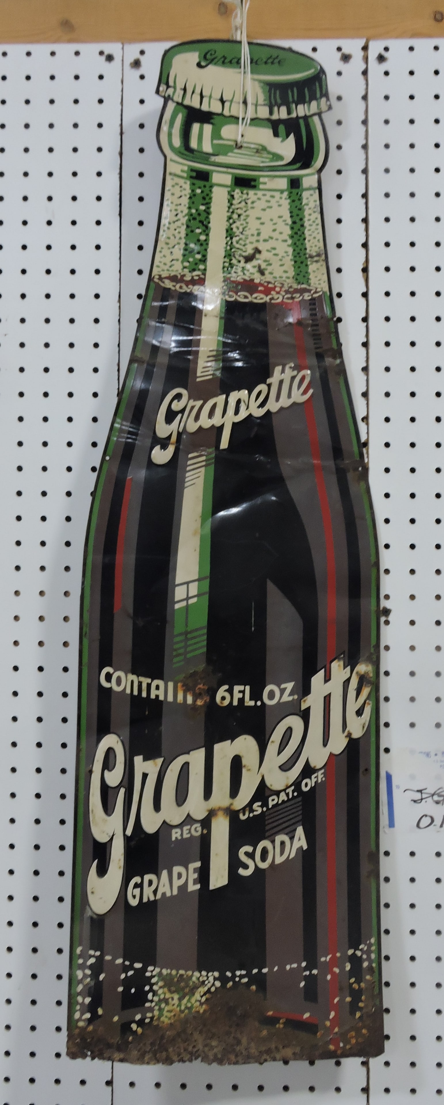 Metal Grapette embossed bottle shaped (1 of 2)