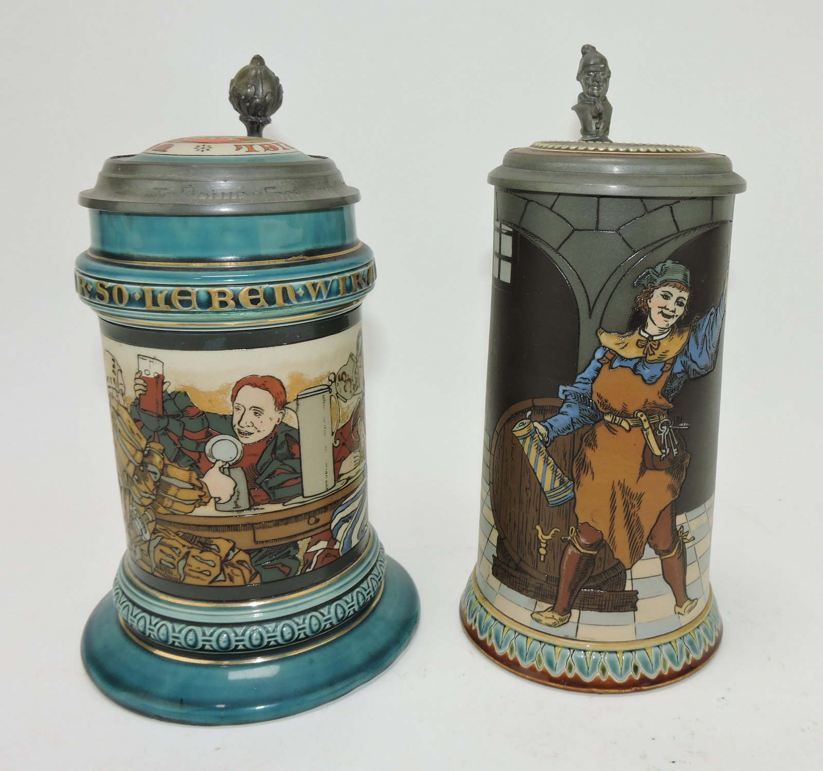 Mettlach lot of 2 steins, #2044 1/2L,: drinking scene AND #2776 1/2L, man in wine cellar (base flake)