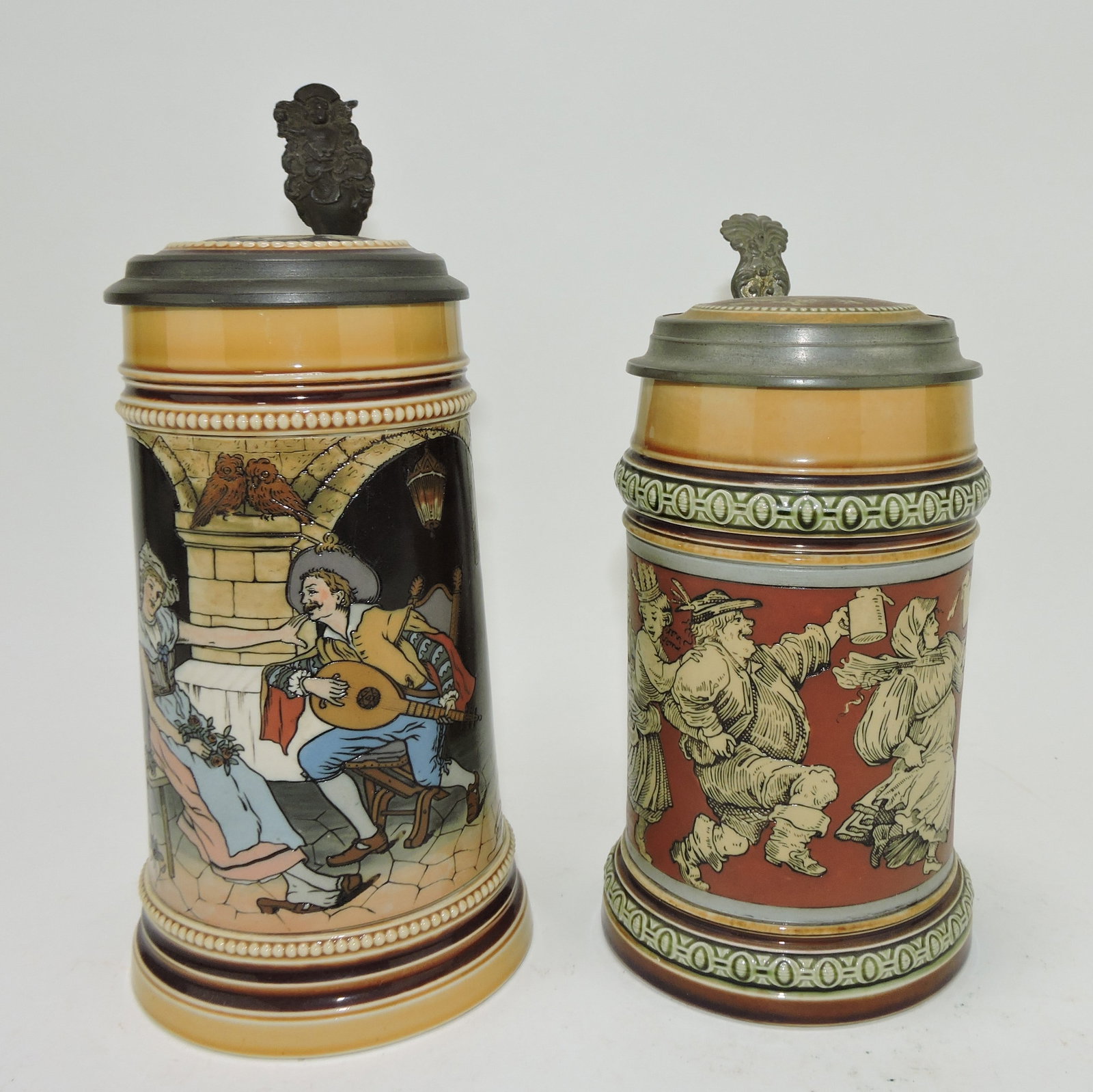 Mettlach lot of 2 steins, #2780 1/2L,: guitar player AND #2057 1/2L, peasant dance