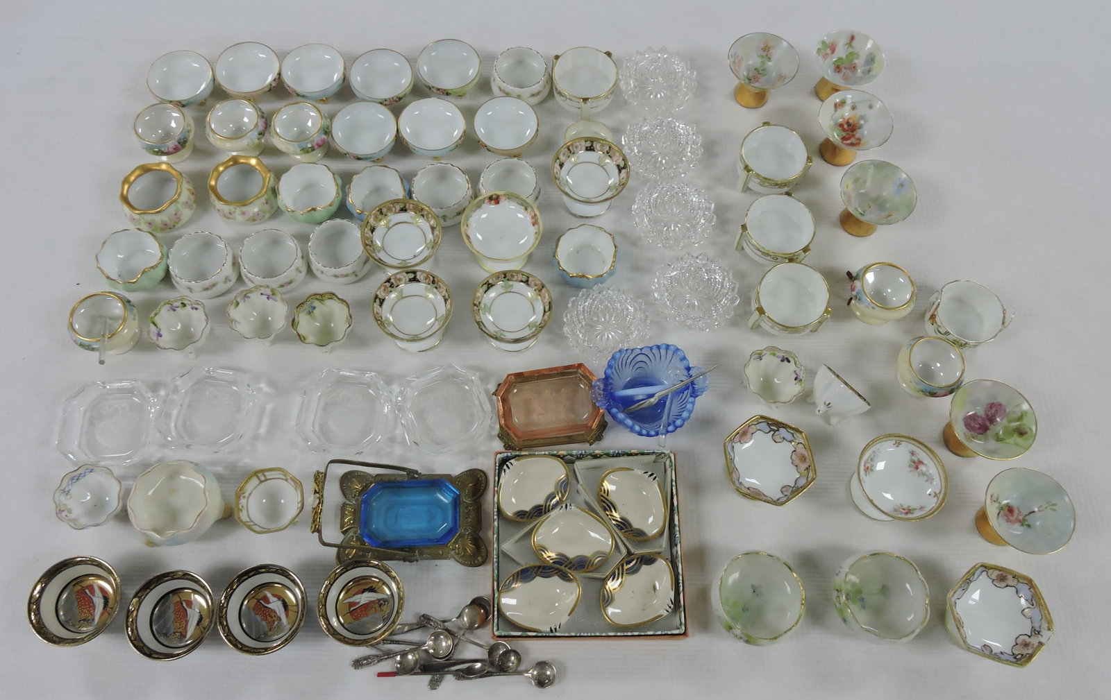 Lot of 77 porcelain and glass salt: cellars and spoons