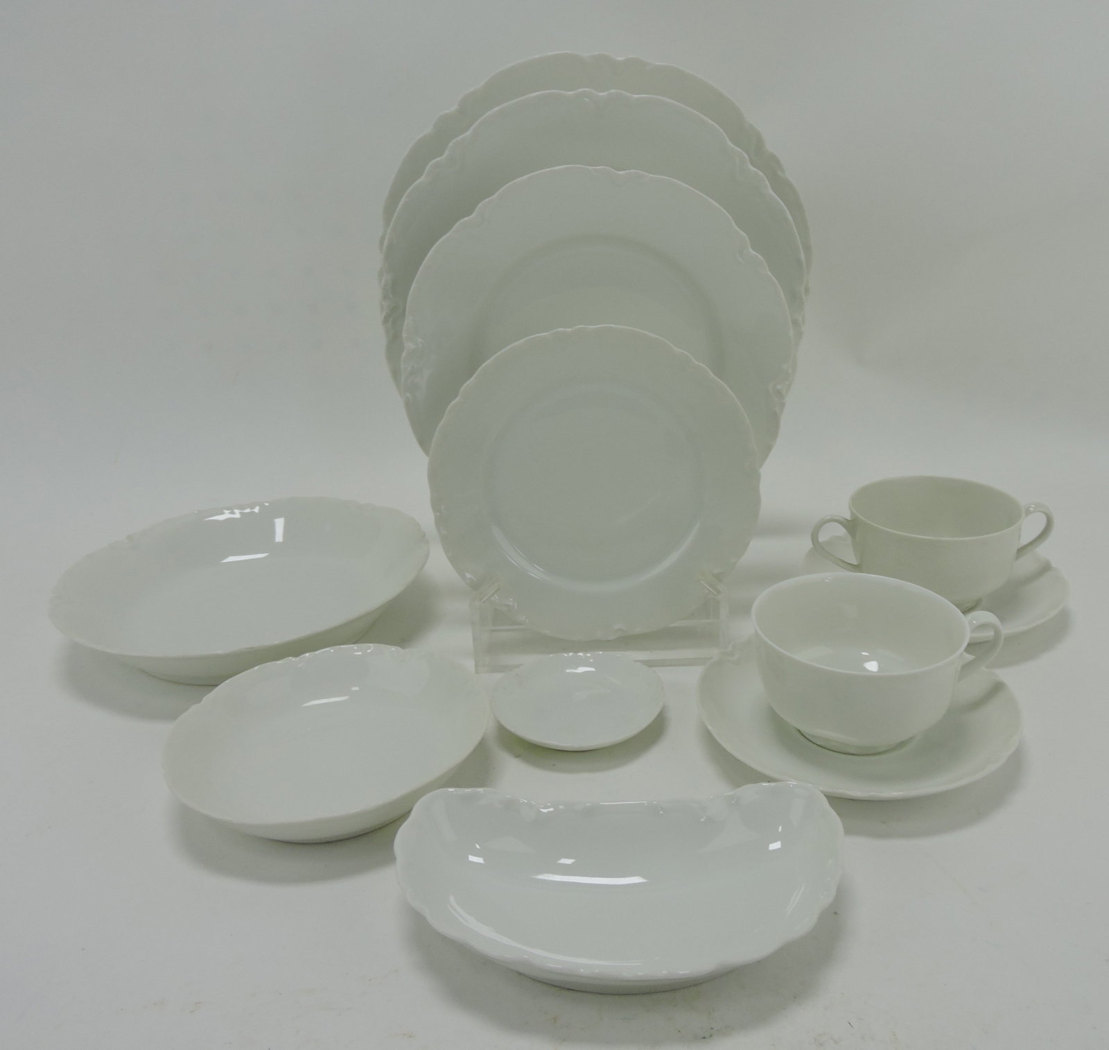 Haviland set of white china: 12 - 9 1/2",: 12 - 8 1/2", 12 - 7 1/2", and 8 - 6" plates, 12 - 5" fruit bowls, 11 - 7 1/2" soup bowls, 12 bone dishes, 12 butter pats, 11 cups, 9 two handled bouillon cups, 21 saucers, 2 round casseroles, cream, s