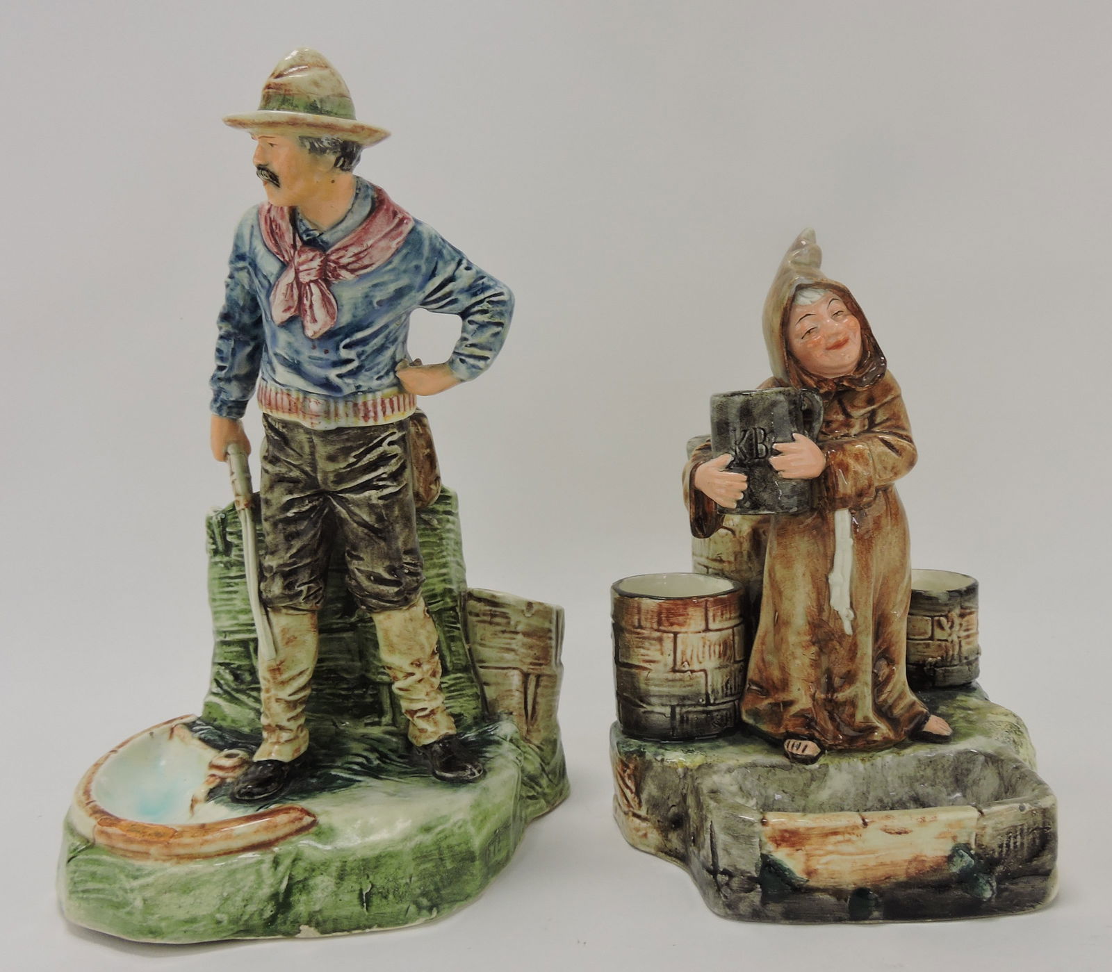 Continental majolica figural match striker,: cowboy (part of gun missing) and monk