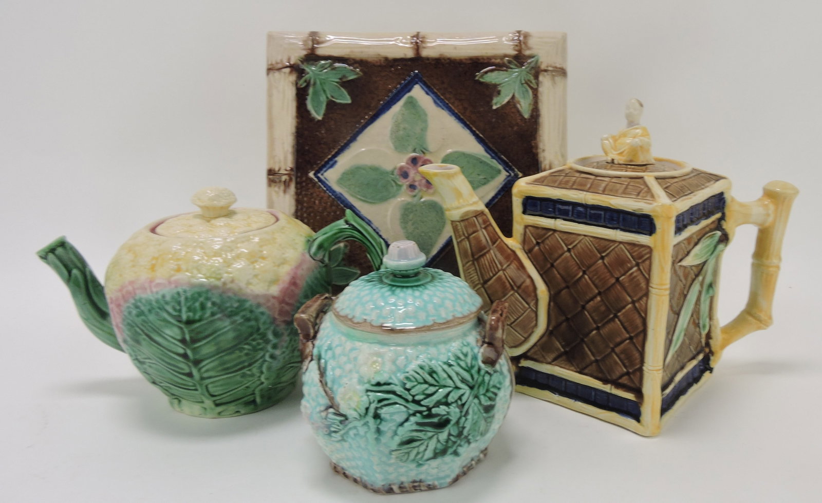 Majolica lot of 2 teapots, sugar, and: square trivet, various condition