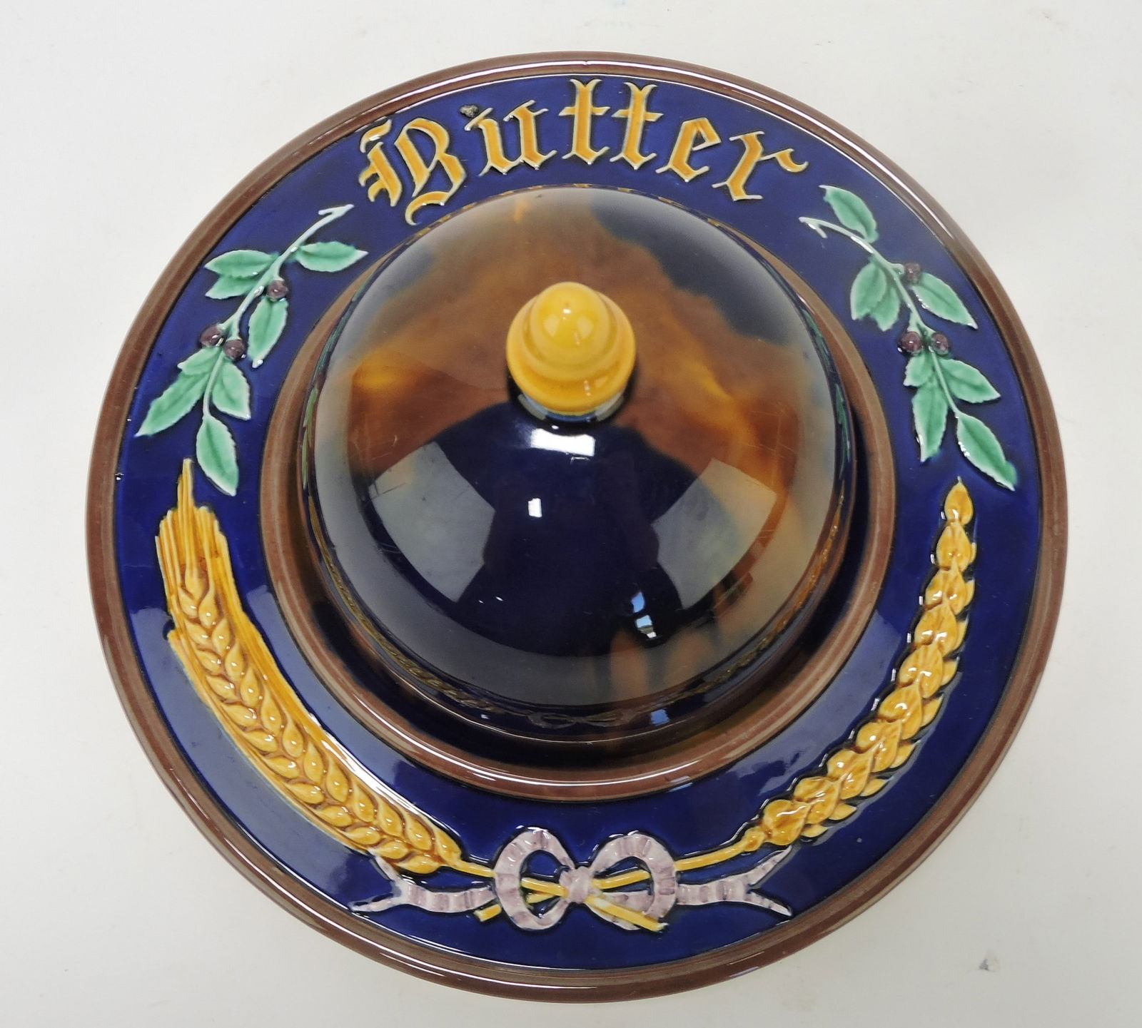 Wedgwood majolica rare butter dish: with embossed 'BUTTER' and wheat on rim of base, 9"d, 5"h, hairline to base