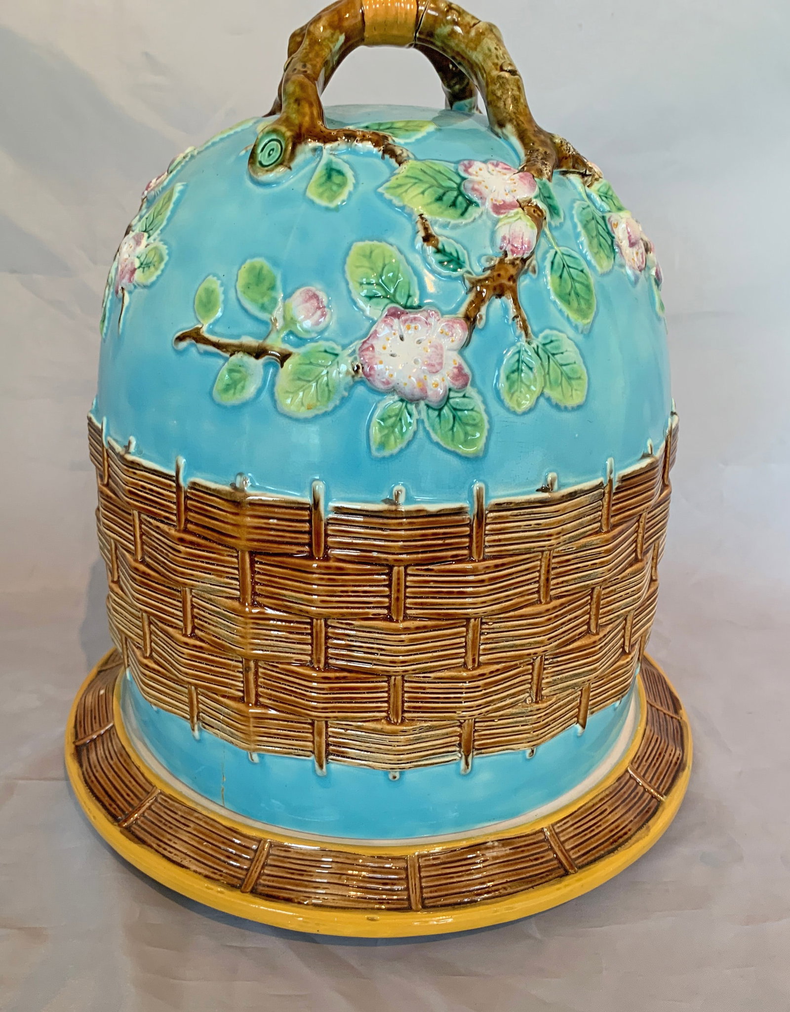 A George Jones full sized majolica apple: blossom and wicker cheese keeper, decorated with a broad wicker band on a turquoise ground with apple blossom in relief great color and definition. Ref. Majolica Mania Vol 2 p248