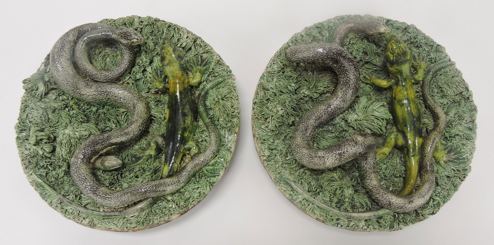 Portugal palissy majolica pair of: wall plaques with snake and salamander on heavy green ground, 9", minor losses