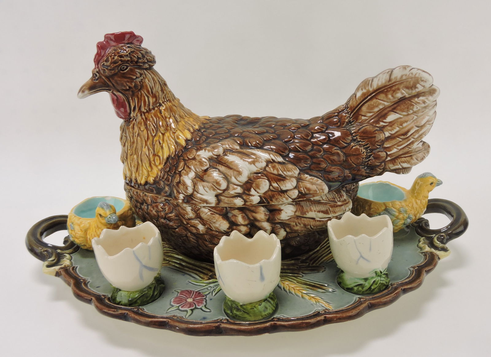 Julius Dressler majolica hen on: nest tureen on fitted tray with 3 chicks and 4 egg shaped egg cups, professional hairline repair to nest, tray 15"l