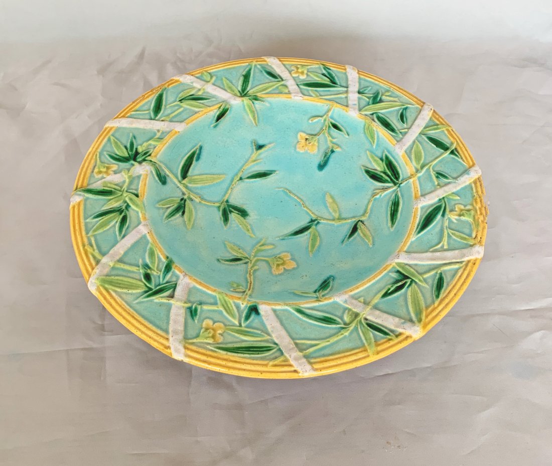 George Jones majolica low compote: standing on a branch base, the top with ribbon detail and yellow border on a turquoise ground with foliage and yellow flowers