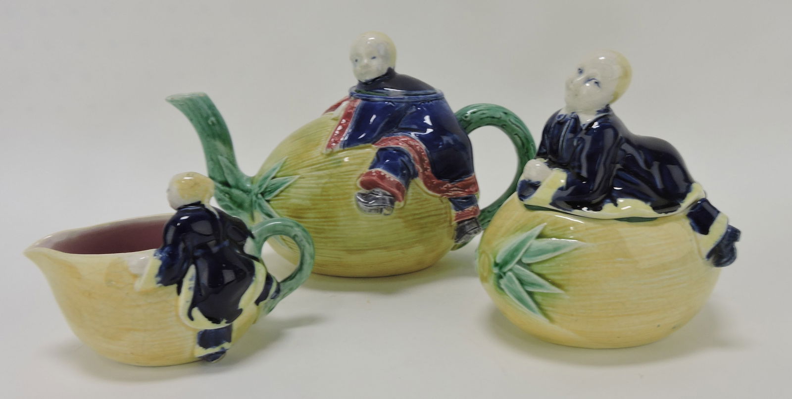 Holdcroft (attributed) majolica three: piece tea set with coconut form body with Chinaman handle. Sue & Harry Thurmon Collection