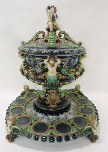 Hugo Lonitz monumental punch bowl: with cover and stand, cover with putti holding clump of grapes, body of punch bowl with 4 tritons supporting rim with ram heads stand with band of dolphins and shells supported by 4 lady feet, 27"h, 2