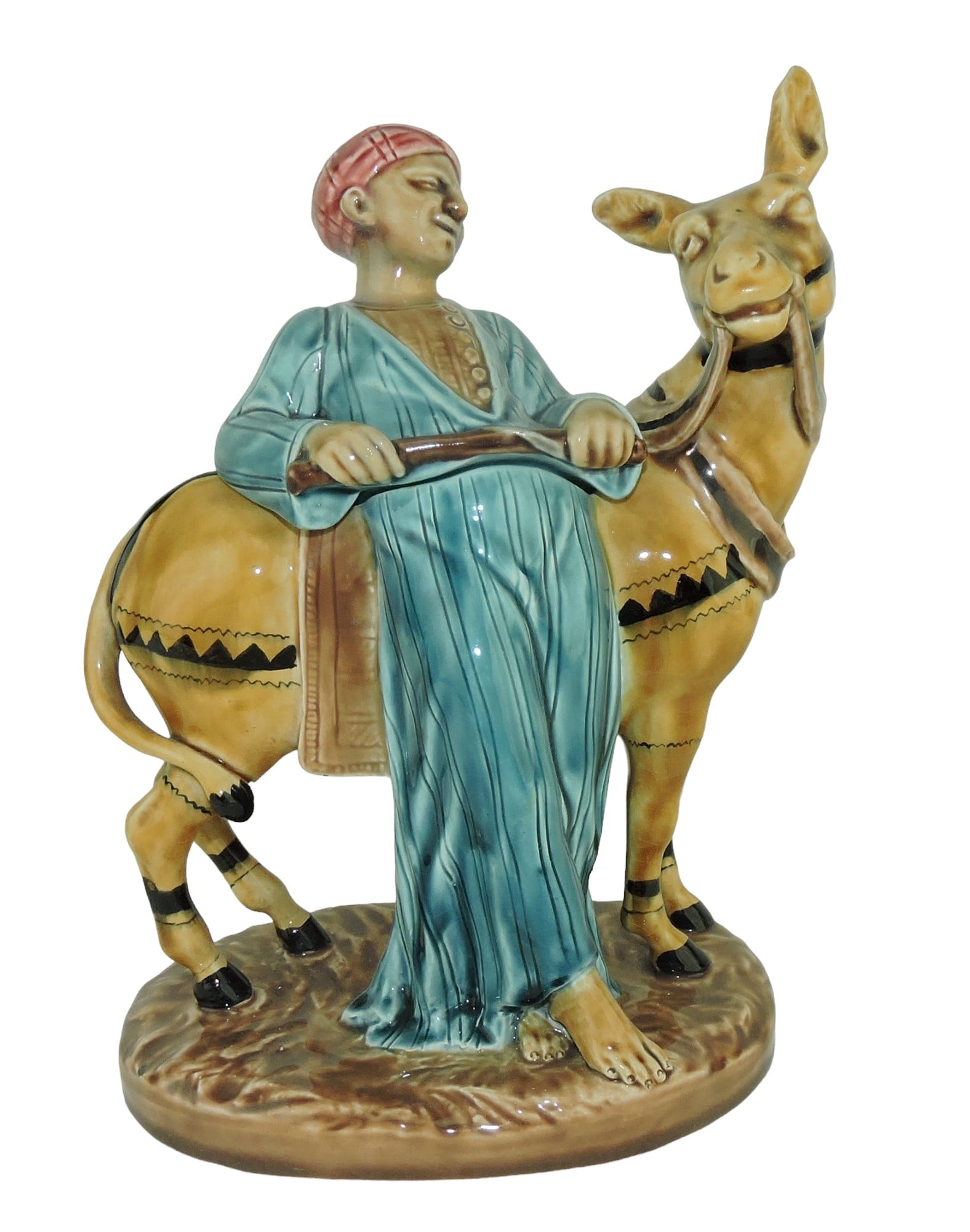 Rare Sarreguemines Majolica: of a Donkey and Driver c.1890 9", shape no. 2172, modelled as a man in Moroccan dress leaning on a donkey, all upon a grassy pedestal base. Catalogued and curated by Nicolaus Boston. Flower Family Col