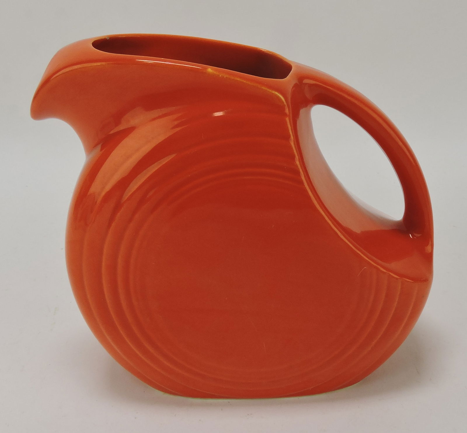 Fiesta disc juice pitcher, red, minor nick (1 of 1)