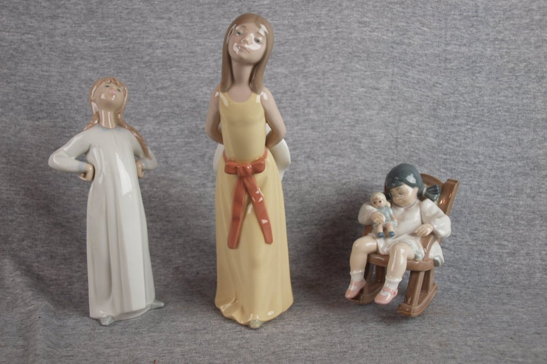 Lladro lot of 3 figures: Lladro lot of 3 figures - girl in night shirt, lady with hat behind her back and girl asleep with doll in rocking chair