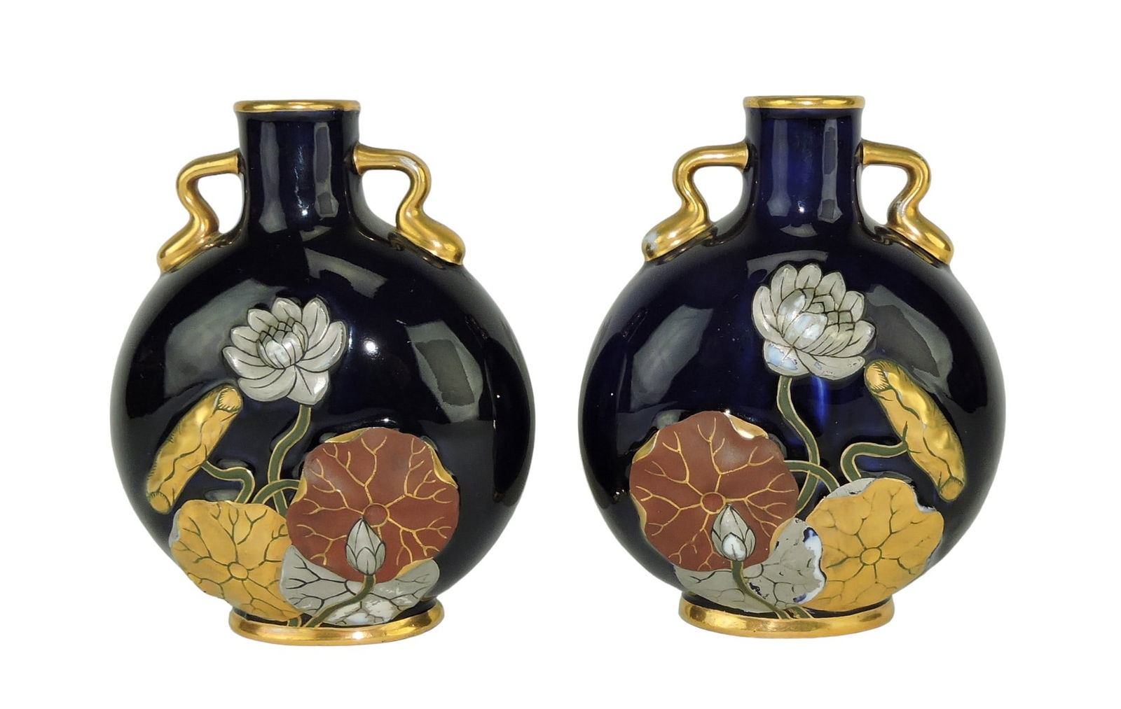 Pair of Coalport Porcelain Aesthetic: Movement Moon Flasks c.1890 each with waterlilies decorated in 22ct gilding and platinum all against a cobalt ground, 6", minor flake to rim of one Catalogued and curated by Nicolaus Boston