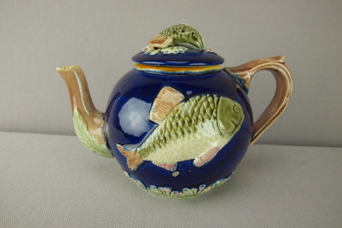 Cobalt majolica teapot with fish in high relief,: Cobalt majolica teapot with fish in high relief, 7"l, 5"h, professional repair to lid rim