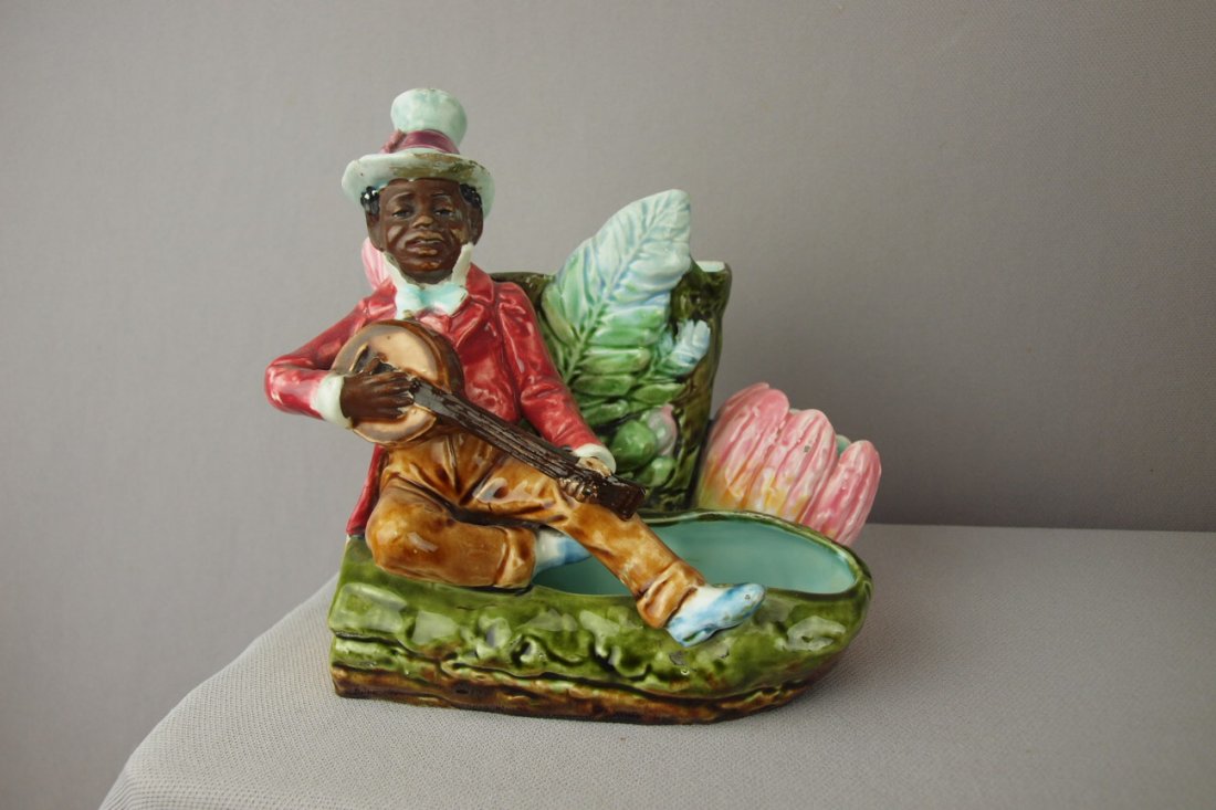 Continental Blackamoor with banjo figural match s: Continental Blackamoor with banjo figural match striker, minor hairline to back, nick to hat rim, 6"