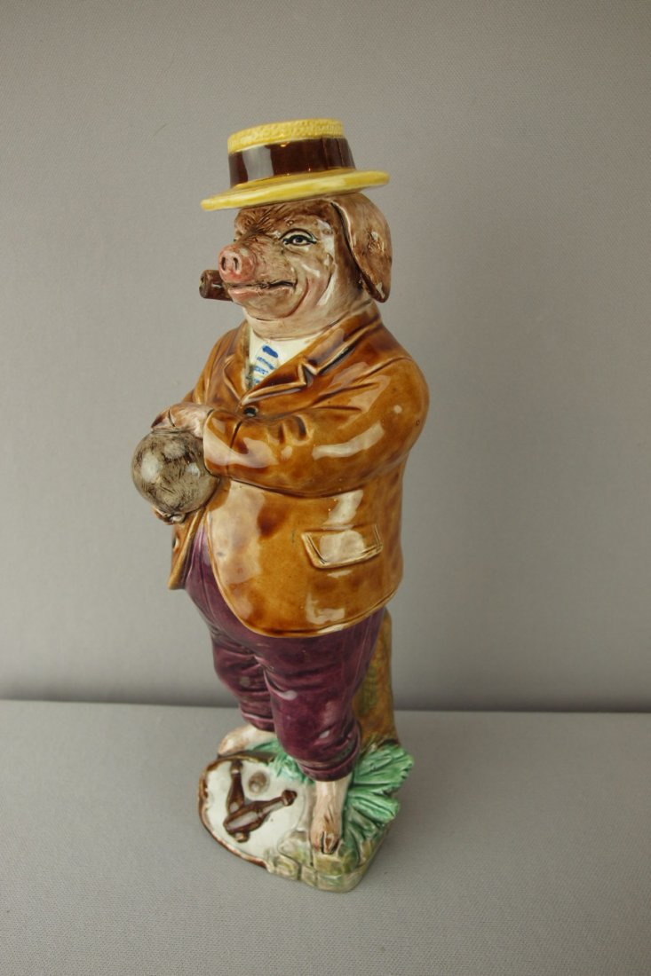 Continental majolica figural bottle of pig bowler: Continental majolica figural bottle of pig bowler with straw hat, professional repair to rim of hat, 12"