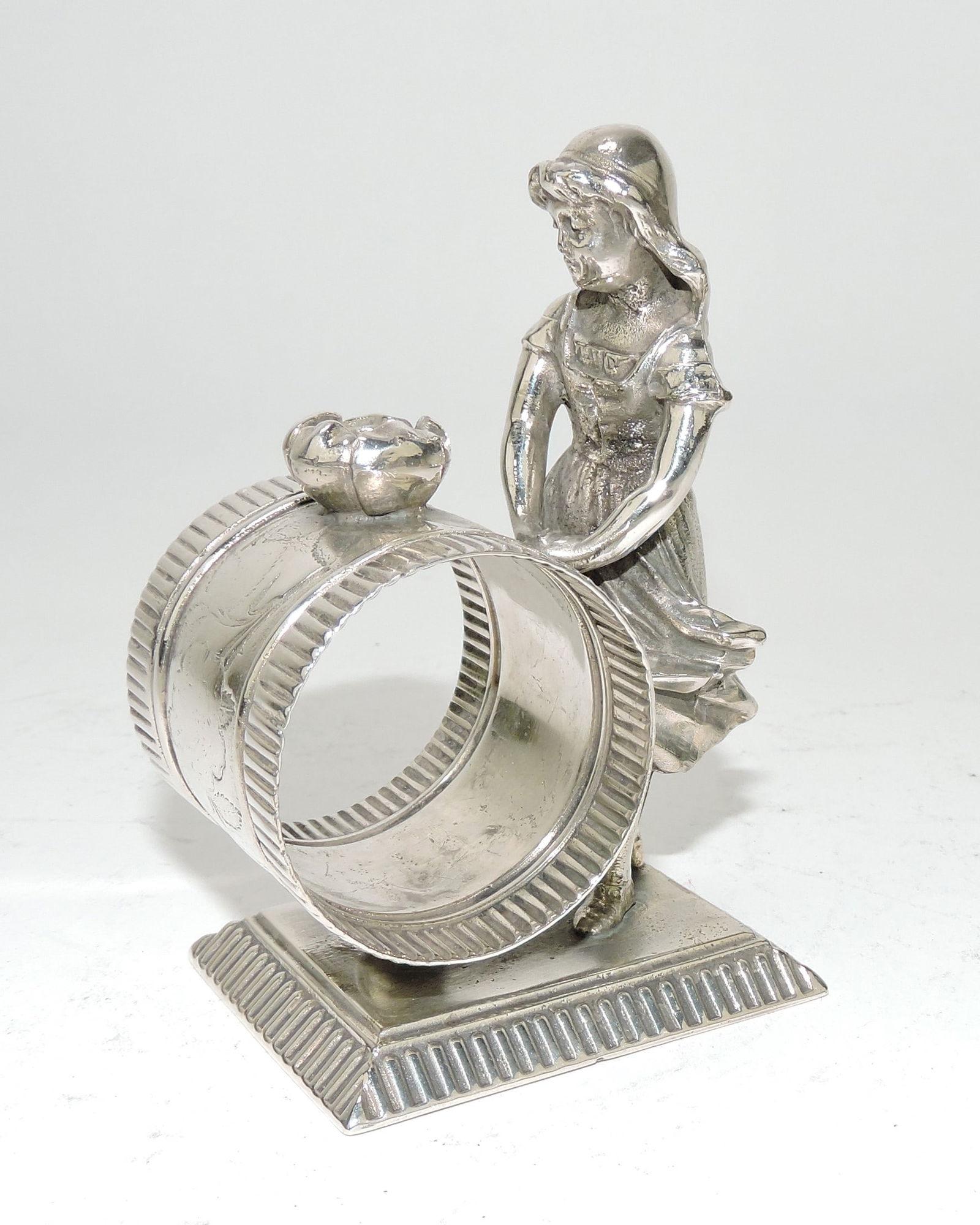 Rockford silver plate figural napkin: ring with girl, 3 3/4"