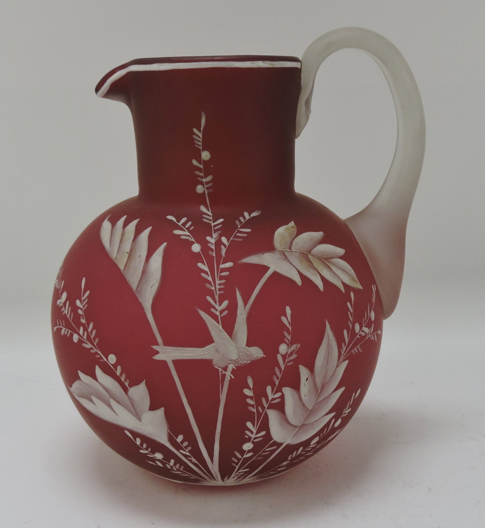 Webb red satin pitcher with enameled: bird and foliage, 7 1/4"