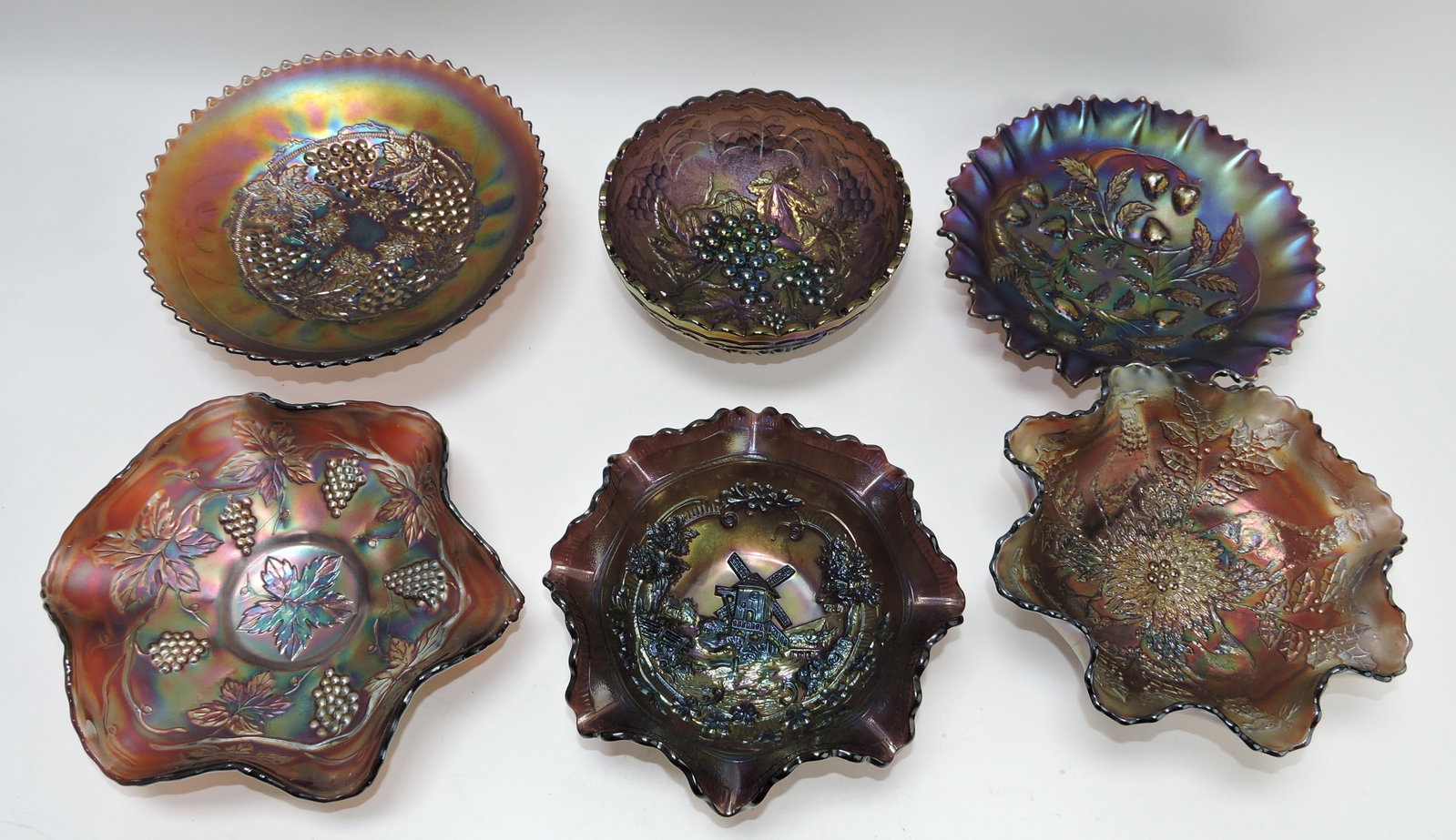 Amethyst carnival glass lot of 6 bowls:: Northwood grape & cable, Imperial grape, Northwood strawberry, Fenton grape, Imperial windmill, Fenton stag & holly