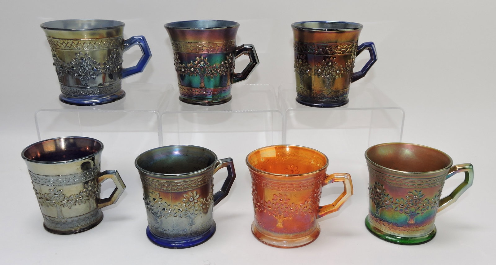 Fenton carnival glass Orange Tree: mugs, 5 blue, 1 marigold, 1 green