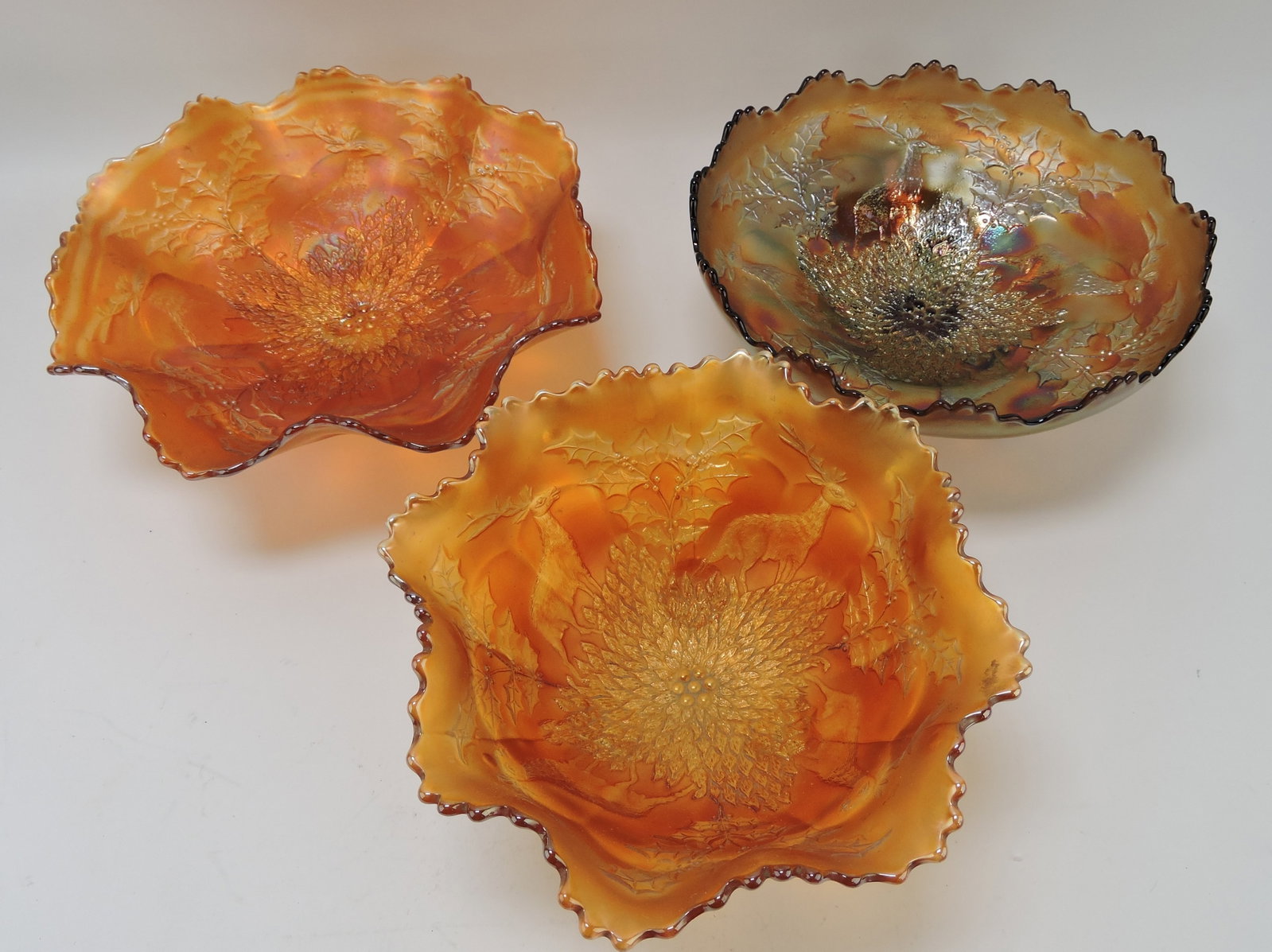 Fenton carnival glass stag & holly lot: of 3 bowls, 2 marigold, 1 amethyst