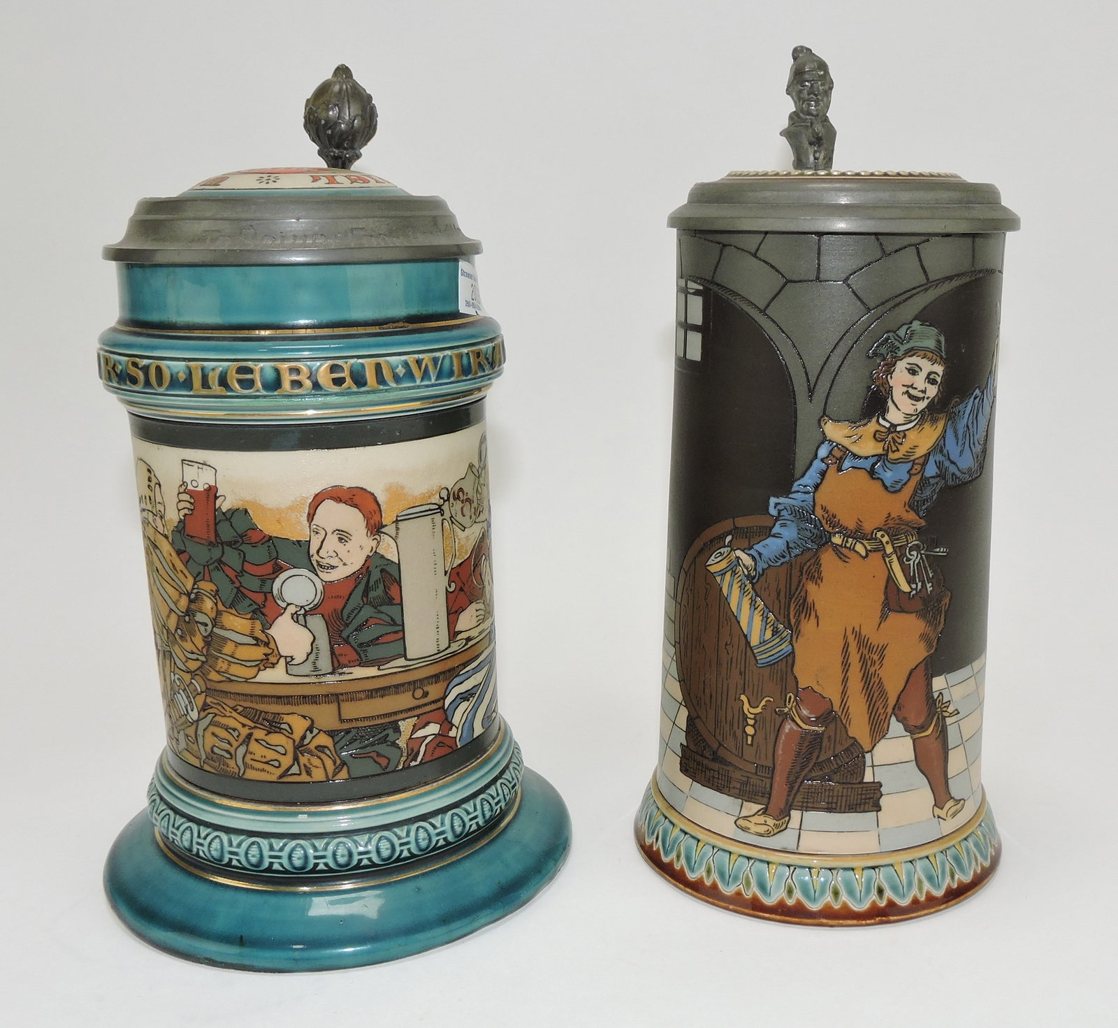 Mettlach lot of 2 steins, #2044 1/2L,: drinking scene AND #2776 1/2L, man in wine cellar (base flake)