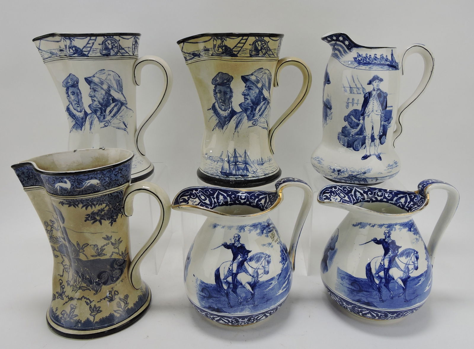 Buffalo Pottery lot of 6 blue and white: pitchers - 2 Marine jugs (staining to one), John Paul Jones, Gloriana (staining), and 2 George Washington