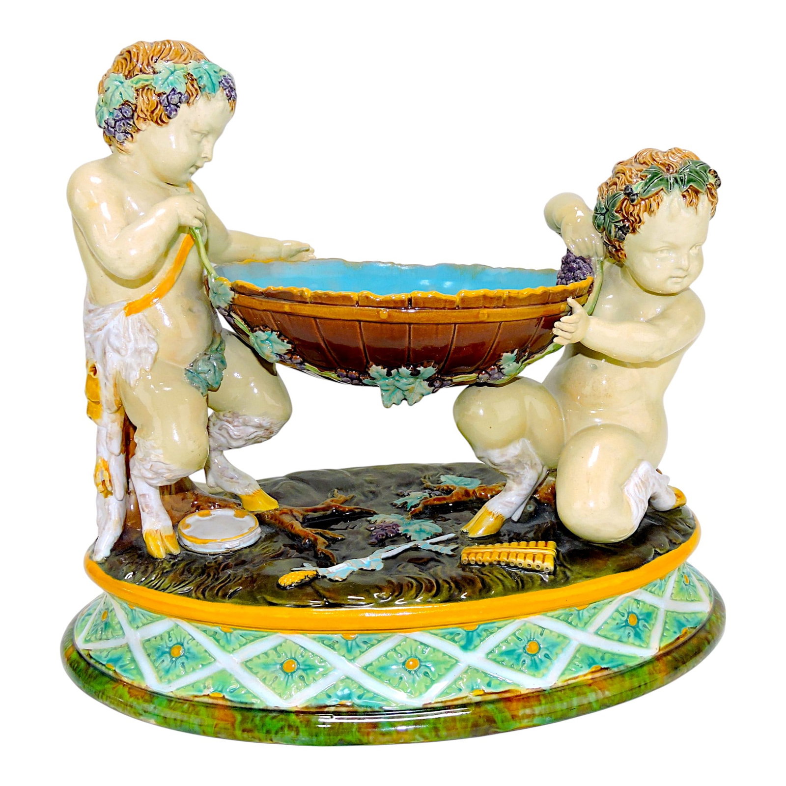 George Jones majolica table center: in form of two cherubs supporting bowl with grapes and wine, 11"h, 12"w