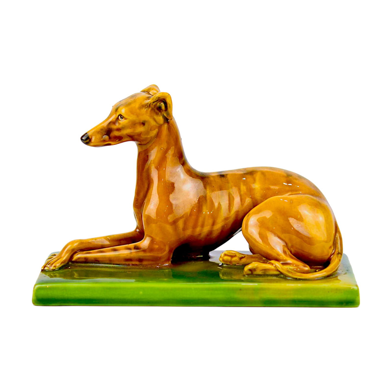 Minton Majolica Greyhound Paperweight: c.1890, probably modelled by Paul Comolera, Shape No. 393. Designed as a recumbent greyhound on rectangular stand. Raised ‘Mintons’ mark to underside. Length: 7 inches Provenance: Nick Bos