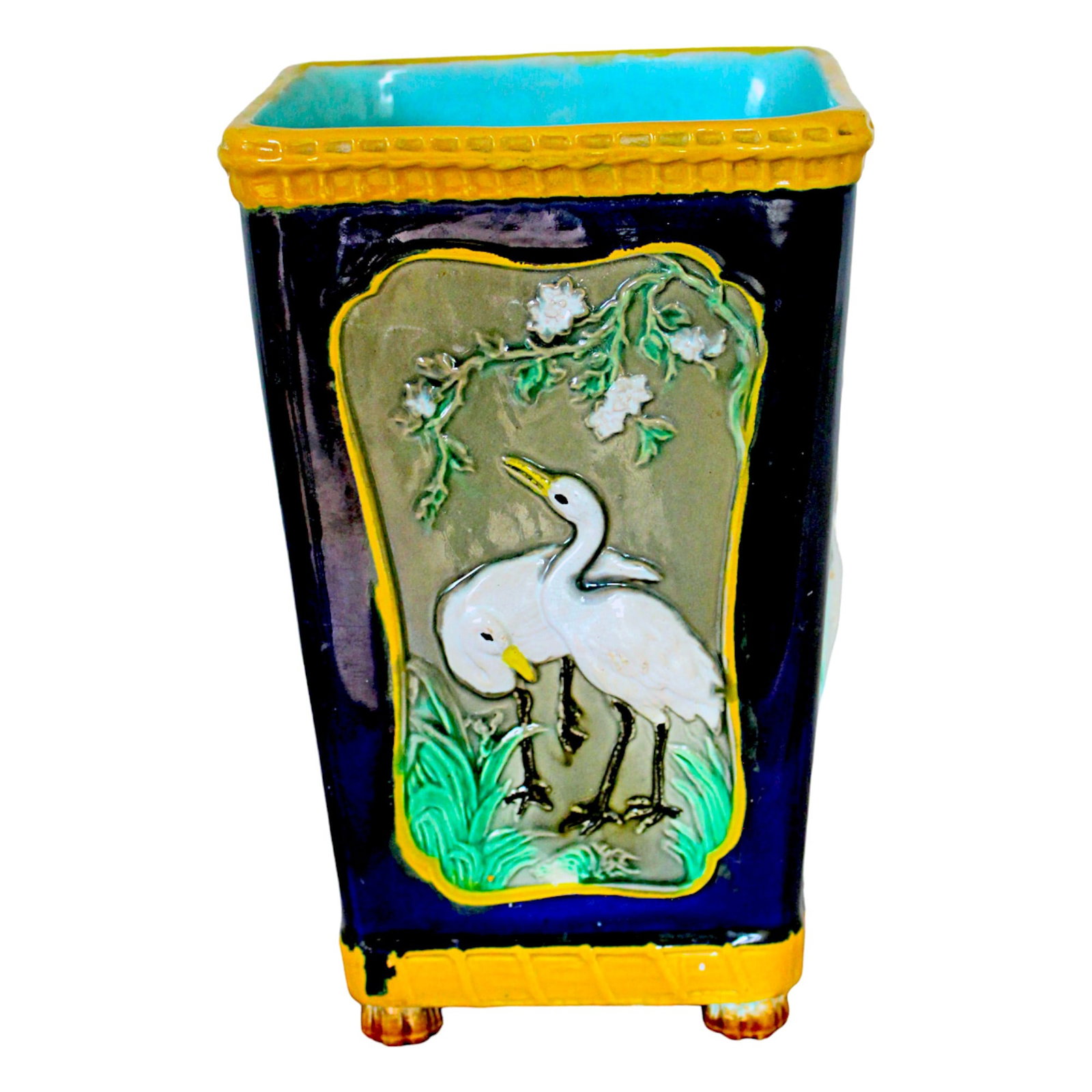 T.C. Brown Westhead Moore majolica: stork vase, with four cobalt panels with yellow border, of two storks standing in a floral and leaf scene, on four bud feet, turquoise interior