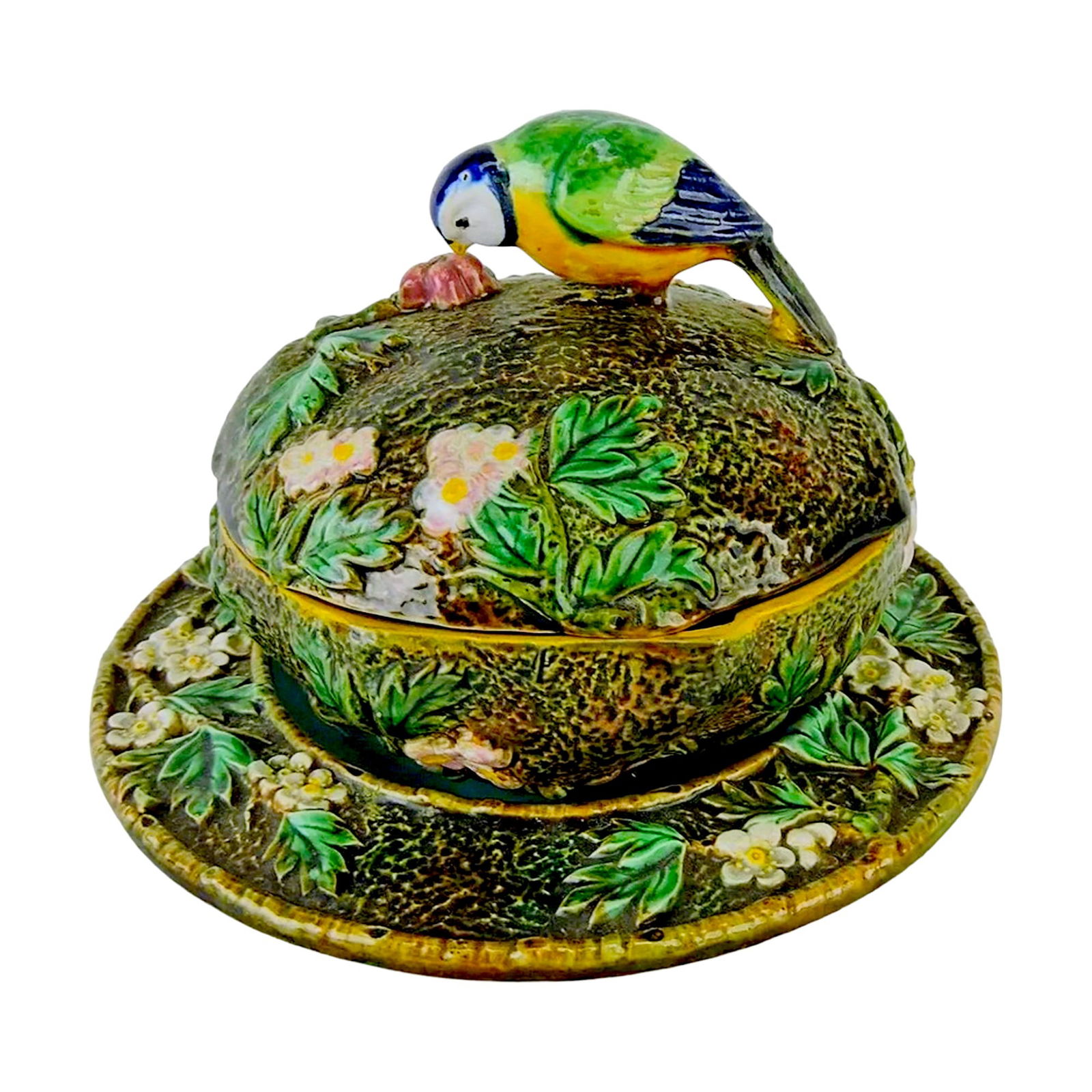 George Jones majolica blue tit butter: dish and stand, C1875 Impressed GJ monogram shape no. 3376 on a rustic ground moulded strawberry blossoms; the domed cover finial modelled as a blue tit pecking fruit. Diameter of bowl 5 1/2"; diamete