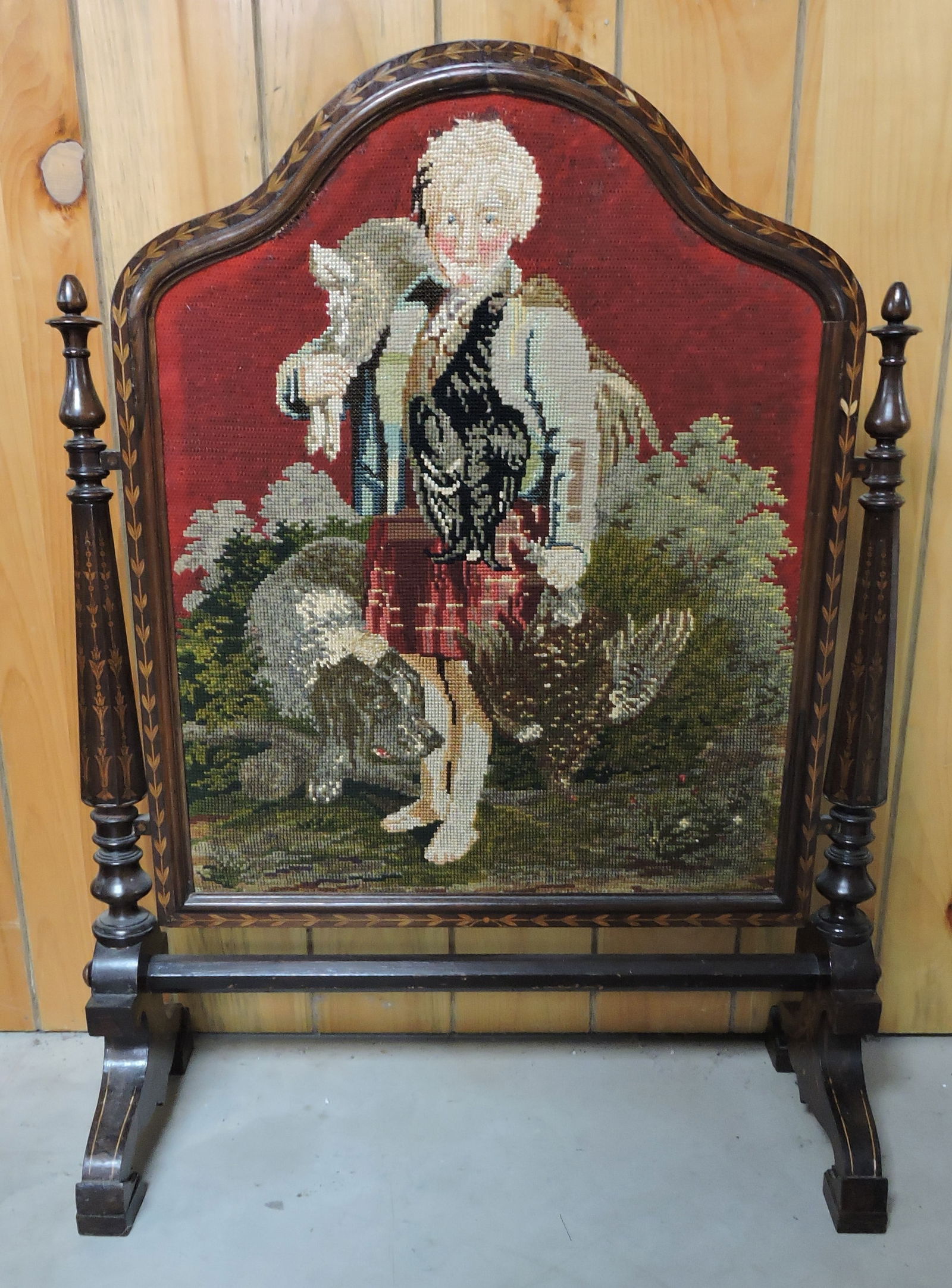 Wooden fireplace screen with needlework: picture of dog on one side and hunter with dog on the other, inlaid leaf and vine frame, 38"h, 27"w