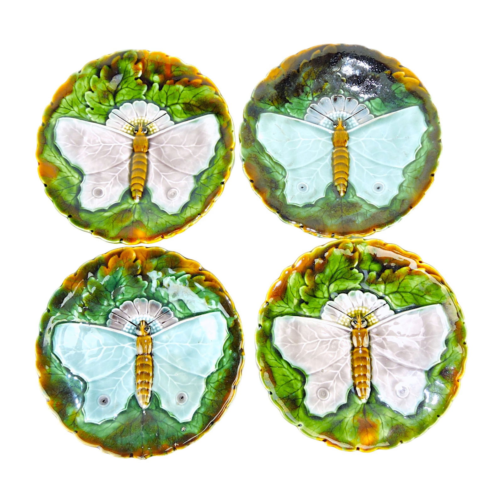 4 Josef Steidl Znaim majolica Butterfly: Plates c.1890, each decorated with a large butterfly against a daisy head and leaves, all after a Minton Majolica butterfly plate designed by William Coleman c.1869; 7 1/4" Catalogued and curated by N