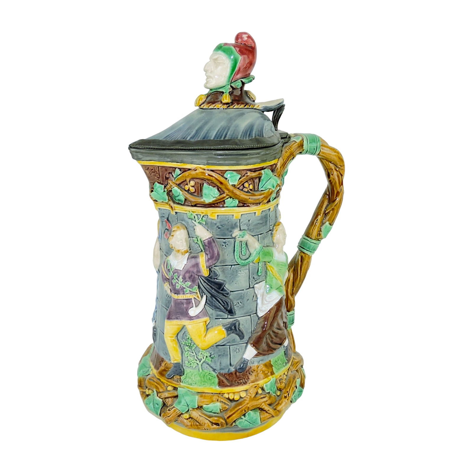 Minton Majolica Tower Jug c.1860,: modelled as dancers in Medieval dress around a tow clad with ivy, the handle of entwined branch, a jester?s head forming the finial, shape no. 1231, 13" Literature: Majolica Mania, Volume 1, page 48;