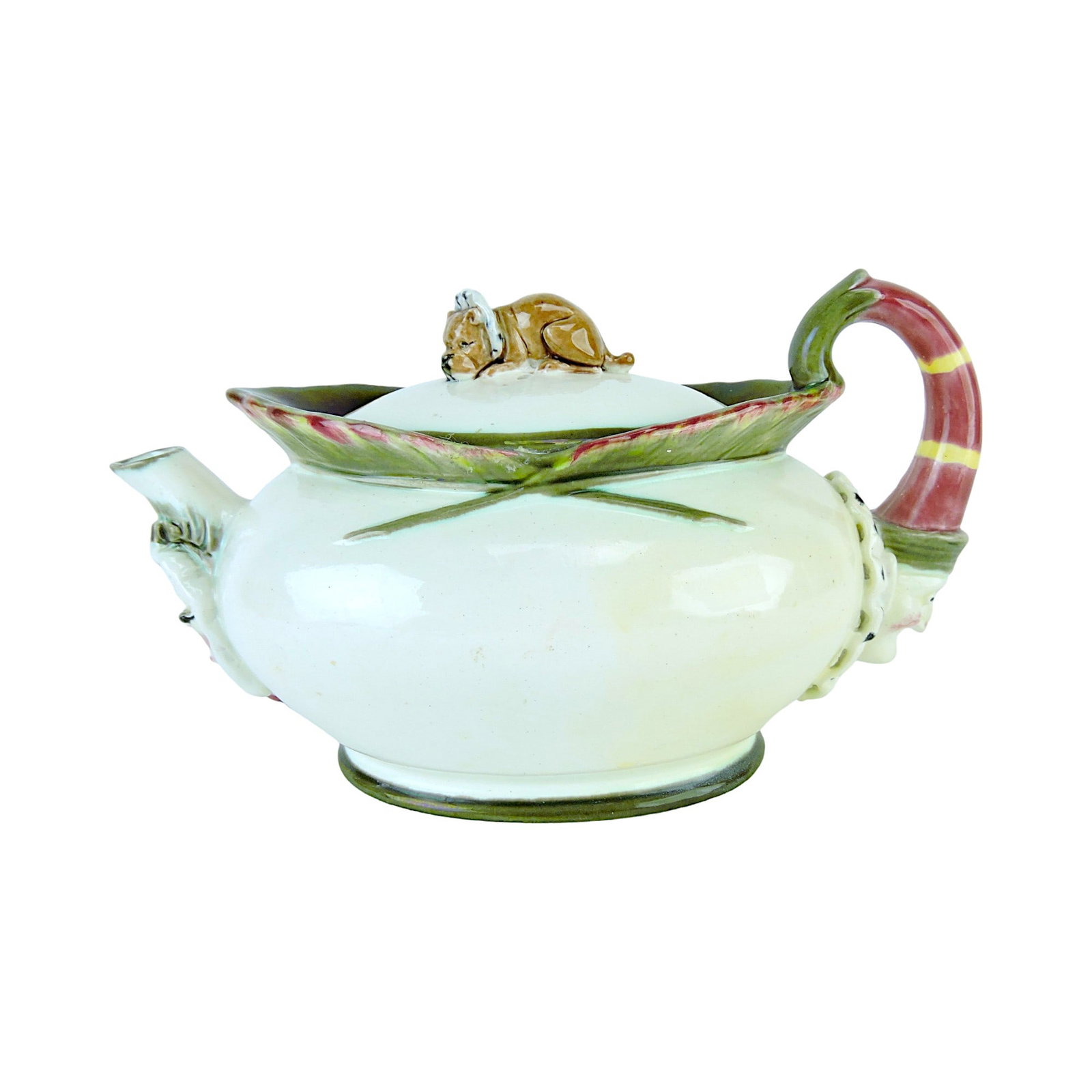 Wedgwood Argenta Majolica Punch: and Judy Teapot and Cover c.1875, the oval body with a feather collar, the handle formed as the head of Punch, a mask of Judy below the spout, 5"h, 8 1/2"l Catalogued and curated by Nicolaus Boston. F