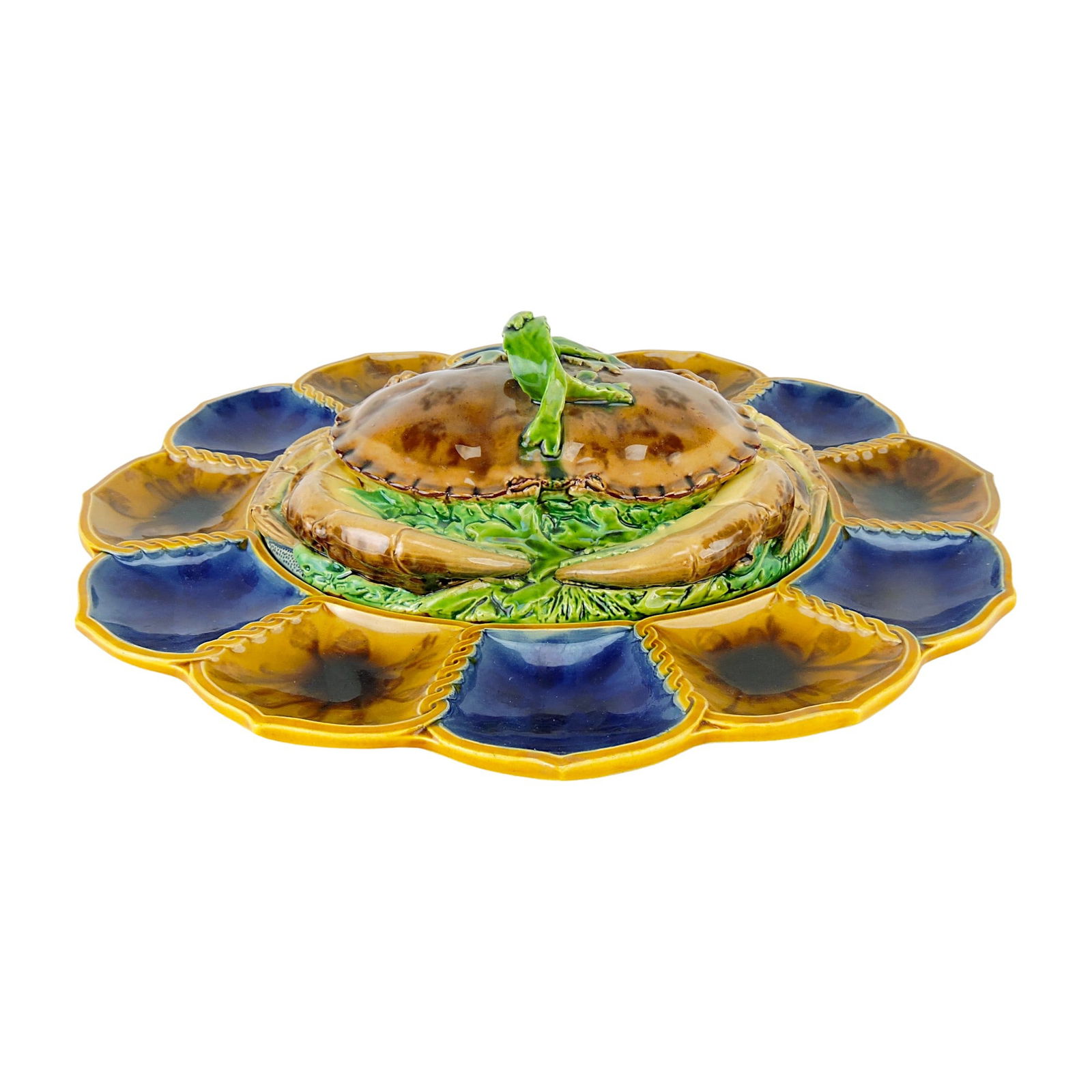 Minton Majolica Crab Meat Tureen: and Cover c.1865, the cover modelled as a red crab on a bed of seaweed, a frond of seaweed forming the handle and all upon an oval stand designed with twelve serving compartments, alternating in cobal