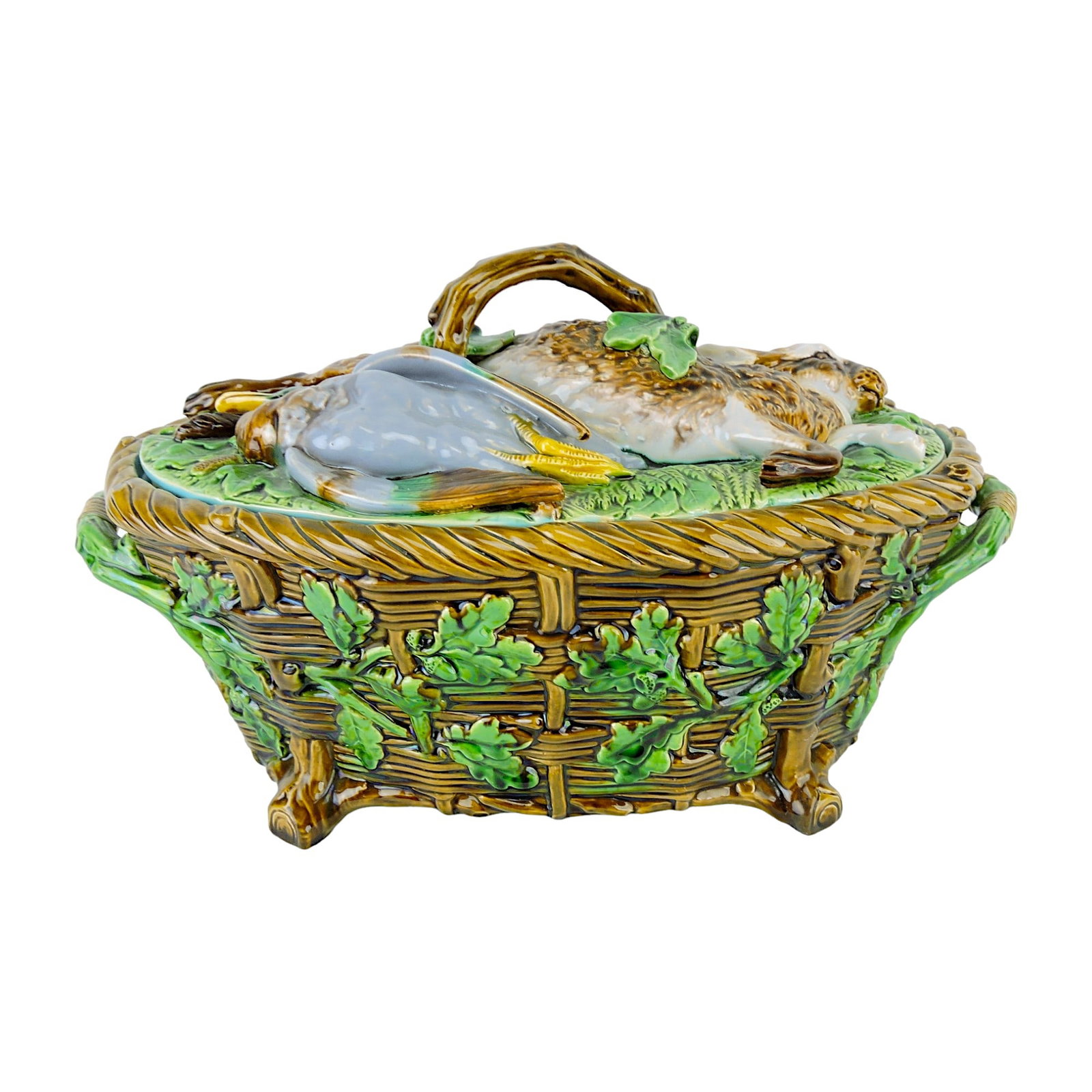 Minton Majolica Game Tureen and: Liner c.1865, the bowl modelled as basket with oak leaves and branch handles, the cover with a hare, duck, mallard duck and back bird on a bed of fern with a buff glazed liner. 8 1/2"h, 14 1/2"w Liter