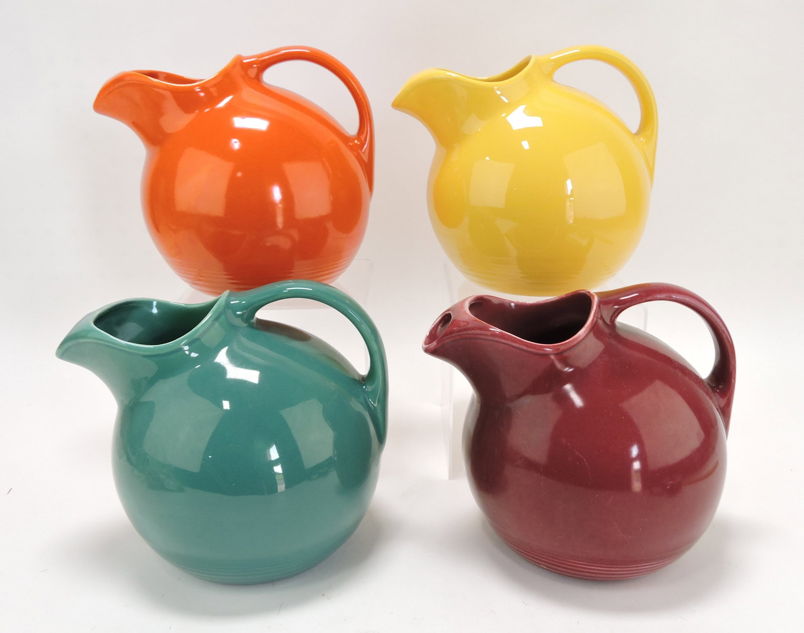 Harlequin service water jug group:: red, yellow, spruce green, maroon