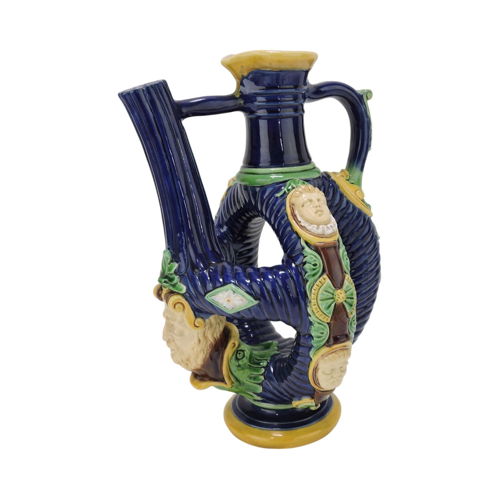 Minton majolica rare Flemish ewer,: the cobalt body designed as two conjoined ribbed rings with white masks and strapwork, 12 1/2"; The Leberfeld Collection