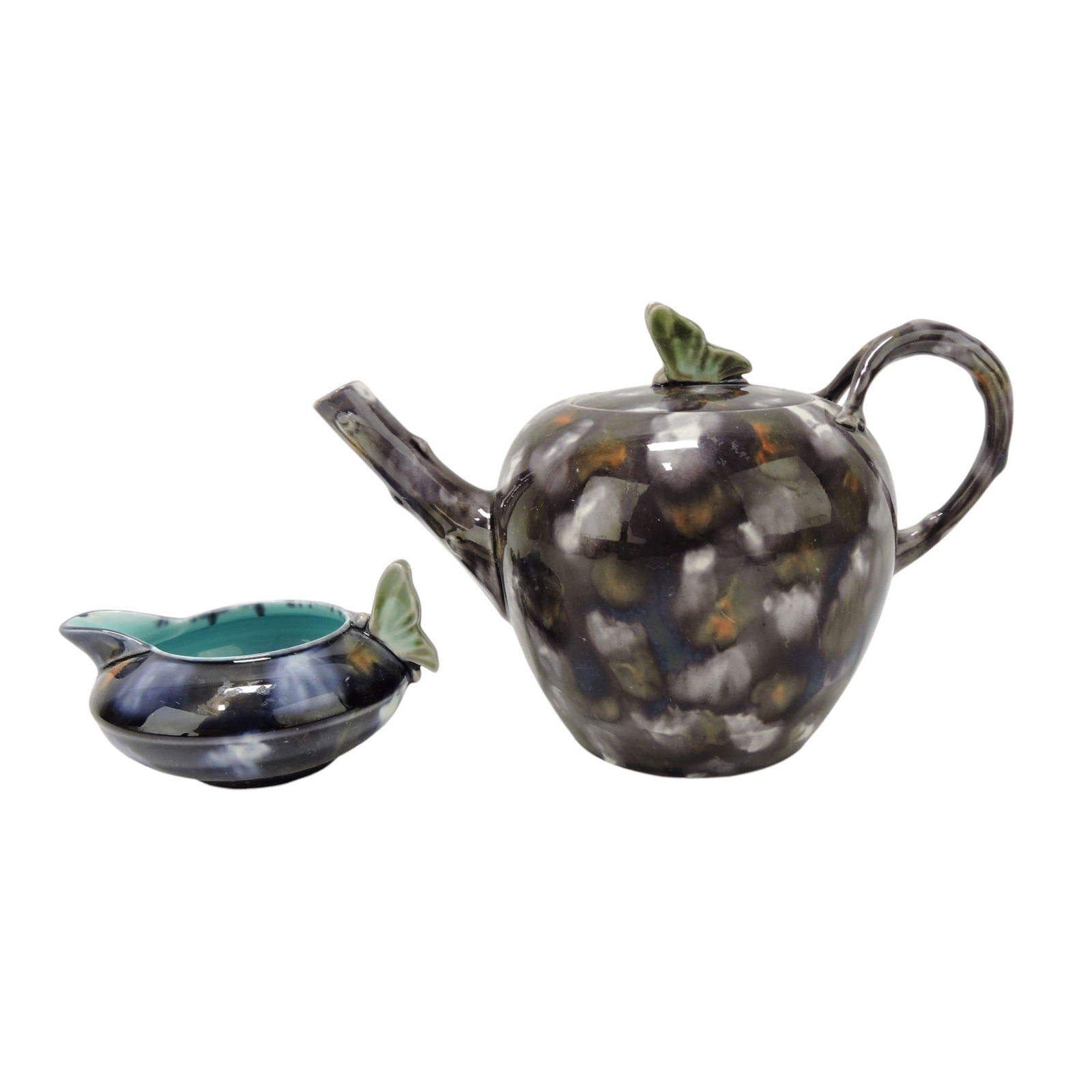 Wedgwood majolica mottled teapot: with butterfly finial and matching creamer with butterfly handle, 4"h. The Leberfeld Collection