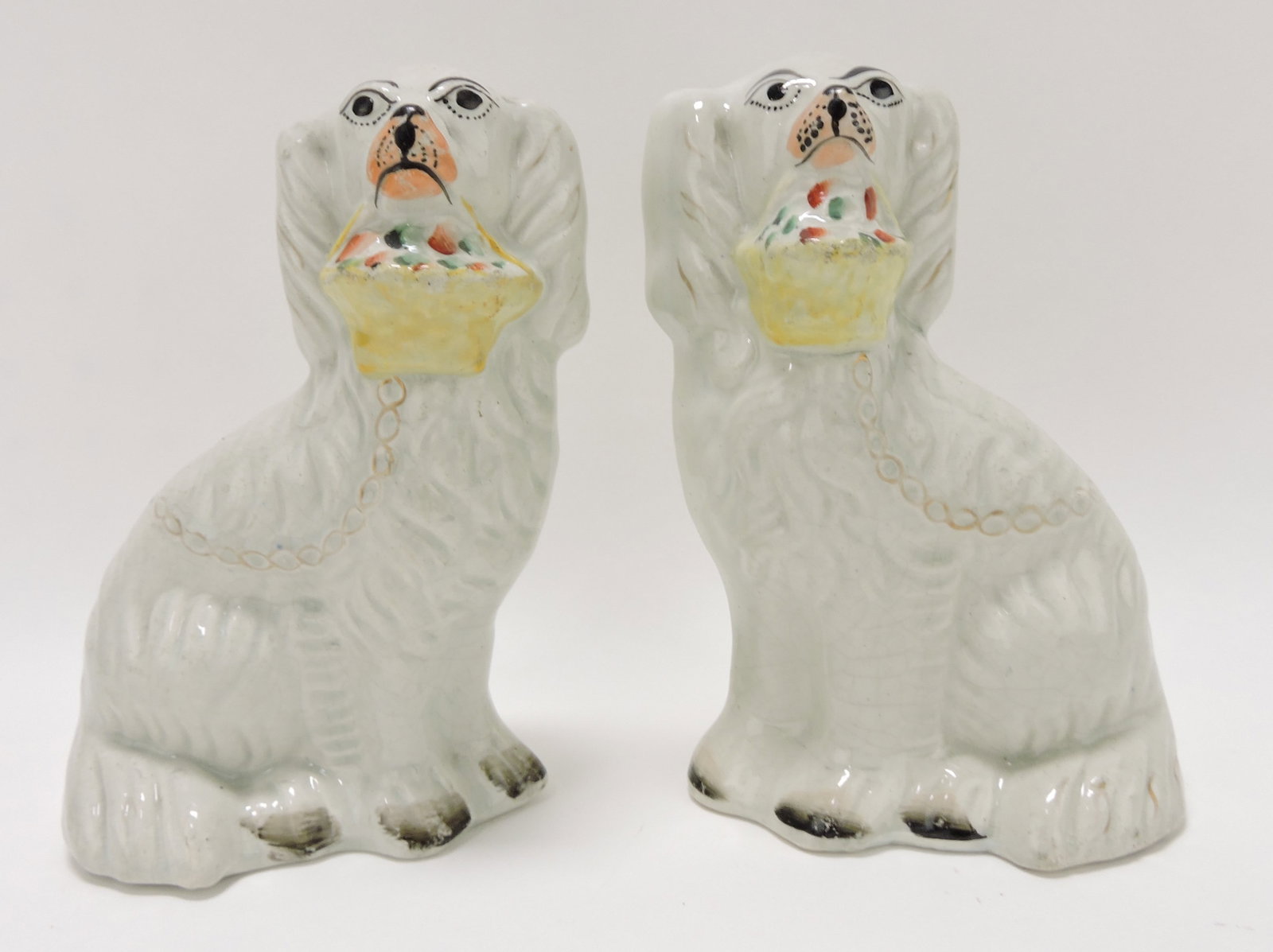 Staffordshire pair of flower basket: spaniels, 7"; hairline to left dog