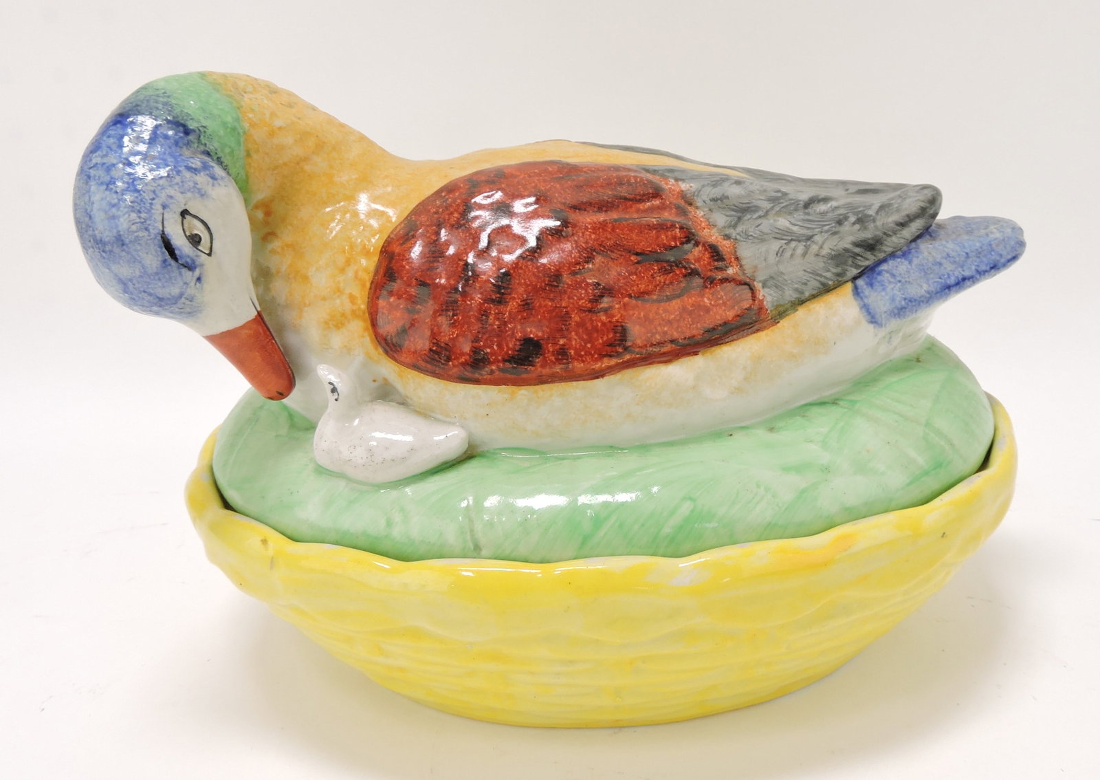 Staffordshire duck with duckling on: nest, 6 1/2"h, 9 1/2"l